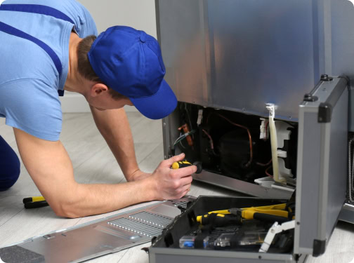 Repairman working on an out of order ice machine