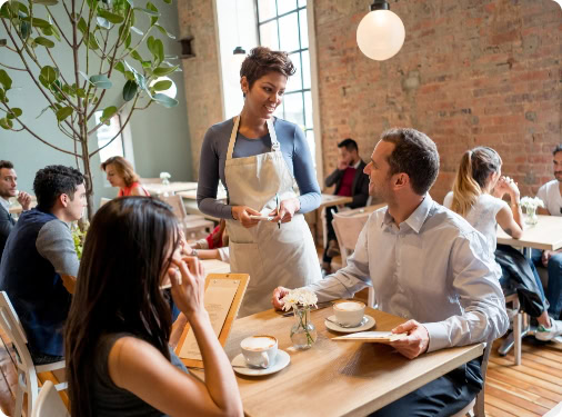 Waitress serving two customers at a restaurant